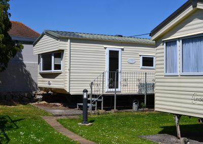 Static caravan on grassy lawn