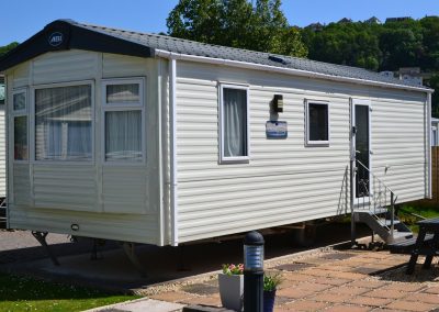 Modern mobile home with steps in sunshine